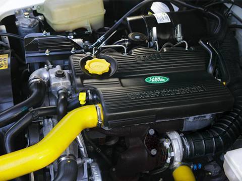 Yellow car silicone hose kits are installed on the engine of Land Rover.