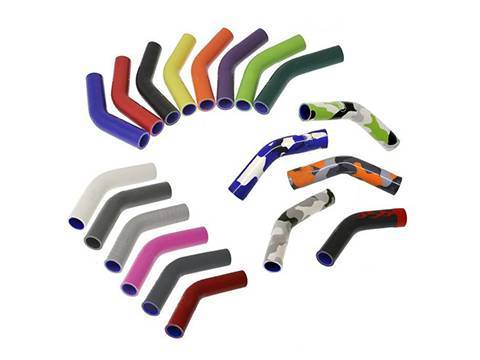 Several different colors and patterns of silicone elbows on white background.