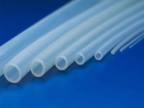 Nine different diameters of food grade silicone hose on blue background.